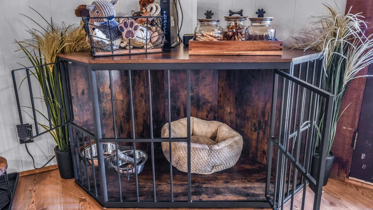 A playful, pet-friendly corner featuring a decorative pet cage, stuffed animals, glass jars with treats, and decorative plants, all arranged with an eye for comfort and inclusion.